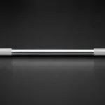 Close-up of silver Olympic barbell shaft showing smooth centre section without knurling