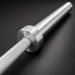 Detailed view of Olympic barbell sleeve and collar with brushed metal finish and premium construction