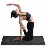 Minimalist yoga practice scene featuring a woman in a backbend pose on a premium black yoga mat against a white backdrop.