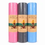 Three rolled-up eco-friendly TPE yoga mats in pink, grey, and blue