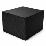 Stack of black rubber gym flooring tiles on a white background, showing layered edges and textured non-slip surface.